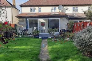 a house with a yard with green grass and a yard at Large One Bedroom House near Twickenham stadium in Isleworth
