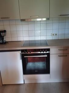 a kitchen with a stove top oven in a kitchen at Ferienclub Erlenbruck in Hinterzarten