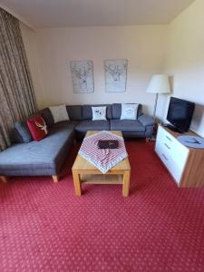 a living room with a couch and a coffee table at Ferienclub Erlenbruck in Hinterzarten