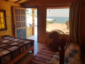 a bedroom with a bed and a view of the beach at New Mabroka in Nuweiba