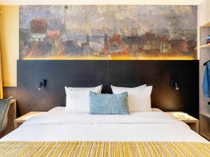 Кровать или кровати в номере Mercure Oostende