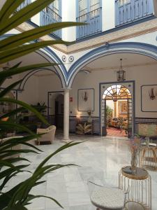 a lobby of a building with blue and white ceilings at Casa Palacio Don Pedro in Seville