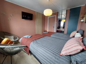 a bedroom with a large bed and a mirror at The perfect stop in Lødingen