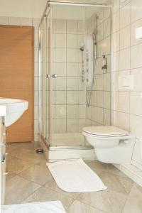 a bathroom with a shower and a toilet and a sink at Hotel Lavender - Oleander Resort in Strunjan