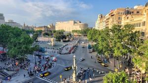 a busy street in a city with cars and people at Hotel Monegal in Barcelona