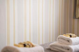 two towels with rings on them sitting on a table at Lovely cosy 2 bed cottage on the Wirral Peninsula in Birkenhead
