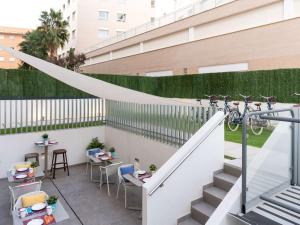 eine Terrasse mit einem Fahrrad, das auf einem Zaun hängt in der Unterkunft ibis budget Valencia Centro Puerto in Valencia