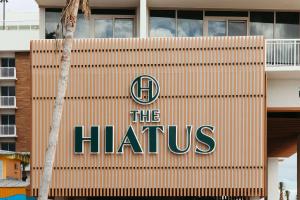 a building with the hirus sign on it at The Hiatus Clearwater Beach, Curio Collection By Hilton in Clearwater Beach