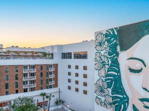 une fresque d'une femme sur le côté d'un bâtiment dans l'établissement The Hiatus Clearwater Beach, Curio Collection By Hilton, à Clearwater Beach