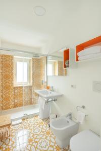 a bathroom with a toilet and a sink at Casa Levante Luxury Apartments Capri in Capri