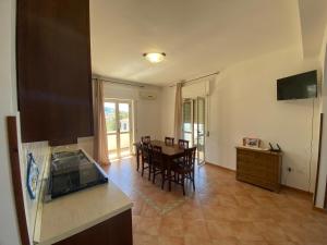 a kitchen and dining room with a table and chairs at Holiday House Nuvola TROPEA CENTRO WIFI PARKING in Tropea