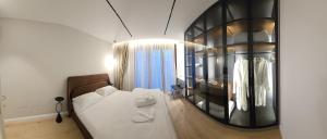 a bedroom with a bed and a large mirror at Center Apartment Easy_Luxury in Tirana