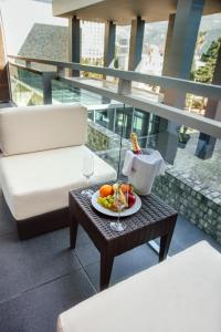 a plate of fruit on a table on a balcony at Avala Resort & Villas in Budva