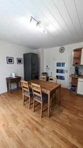 a kitchen with a wooden table and chairs at Ferienhaus Dhrontal in Neumagen-Dhron