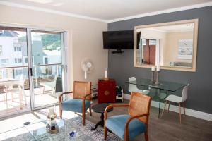 a living room with a glass table and chairs at Waterfront- 11 South Quay in Knysna +46 photos