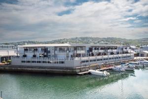 a large white building with boats in the water at Waterfront- 11 South Quay in Knysna