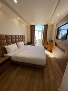 a bedroom with a large bed and a television at Entranceway Resort in Mussoorie