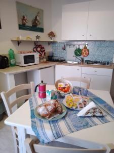 a table with two plates of food on it in a kitchen at Al Geranio B&B in Furore