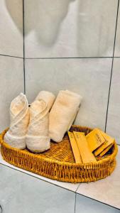 a basket with towels and napkins on a tiled floor at The Leith in George Town