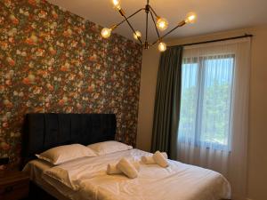 ein Schlafzimmer mit einem großen Bett mit Blumentapete in der Unterkunft Feel Georgia in Batumi