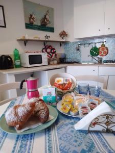 a table with two plates of food on it at Al Geranio B&B in Furore