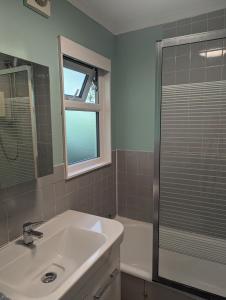 a bathroom with a sink and a shower at Springside Chalet20 in Tywyn