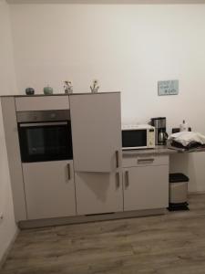a kitchen with a counter with a microwave and a stove at Appartment Herten - Auch zur EM 2024 Arena AufSchalke in Herten