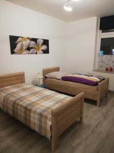 two beds sitting in a room with at Appartment Herten - Auch zur EM 2024 Arena AufSchalke in Herten