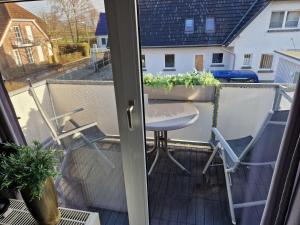 a balcony with a table and chairs at Köster, Birgit FW 5 in Zingst