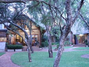 a group of trees in front of a building at Monkey Thorn in Roodeplaat