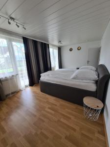 a bedroom with a large bed and a wooden floor at Wolke7 in Erbach im Odenwald