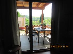 an open door to a patio with a table and chairs at Casa Schönblick & E-Ladestation-Bike Garage in Limburg an der Lahn
