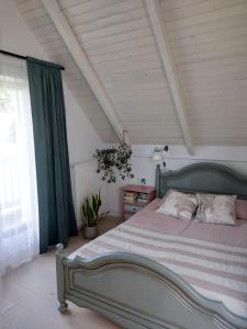 a bedroom with a large bed and a window at Biały Domek in Tylmanowa