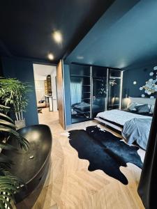a bedroom with a large bed and a dark blue wall at Shades of Cluj Napoca in Cluj-Napoca