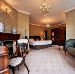 a bedroom with a bed and a desk and a chair at Seaview House Hotel in Bantry