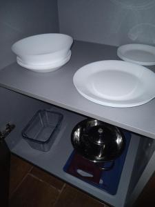 a counter with two plates and bowls on it at El tero y el Hornero Frente in Albolote +19 photos