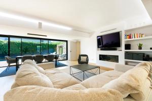 a living room with a large couch and a table at Rosario Pool Villa in Cascais