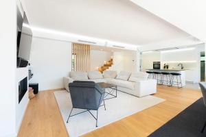 a living room with a white couch and a table at Rosario Pool Villa in Cascais