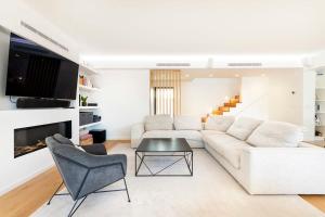 a living room with a white couch and a table at Rosario Pool Villa in Cascais