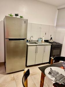 a kitchen with a stainless steel refrigerator and a stove at Hermoso Departamento en Vicente lopez in Vicente López