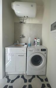 a laundry room with a washing machine and a sink at Villa des Arts - Taormina in Taormina +42 photos