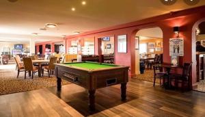 a living room with a pool table in it at Seaview Holiday Rentals - Seawall in Whitstable