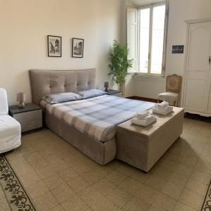 a bedroom with a large bed and a chair at Maison Cavalleggeri in Rome