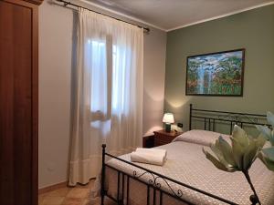 a bedroom with a bed and a window at Il Melograno in Torino di Sangro