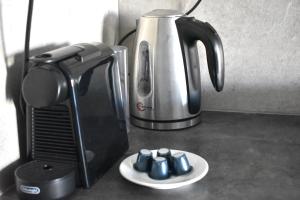 a coffeemaker and a coffee maker on a counter at Konan's cosy condo in Kastellákia
