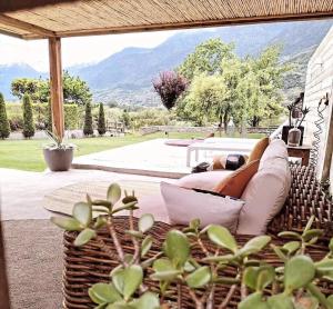 a person laying on a couch on a patio at Ca' Dottori in Albosaggia