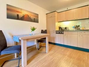 a kitchen with a table and chairs in a room at Haus Inge in Heringsdorf