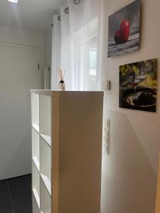 a white room with a shelf and a wall at Kick Appartament am Schloss in Schwetzingen
