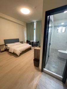 a bedroom with a bed and a tub and a sink at 新化61行館民宿 