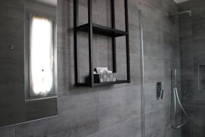 a bathroom with a shower with a mirror and a window at la Luna Blu Malpensa camera matrimoniale Diamante in Somma Lombardo +13 photos
